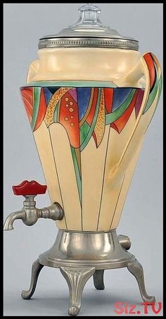 an old fashioned coffee pot with a faucet on it's stand, decorated with multicolored designs