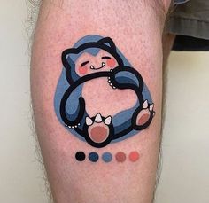 a person with a bear tattoo on their leg and the word c is written in different colors