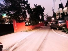 a car is driving down the street at night