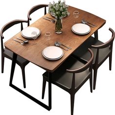 a wooden table with white plates and silverware on it, surrounded by black chairs