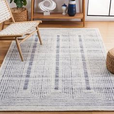 a living room area with a rug and chairs