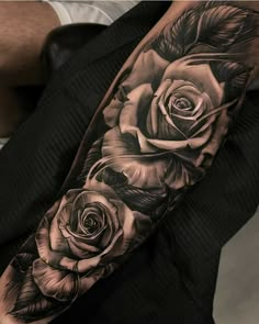 black and white roses tattoo on the arm