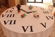 a white table topped with a giant clock