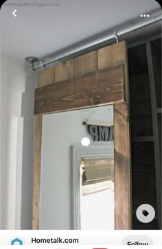 a mirror hanging on the side of a wall next to a shelf with an amp sign