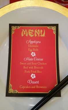 a menu on a plate with chopsticks next to it