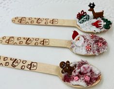 three wooden spoons decorated with christmas decorations