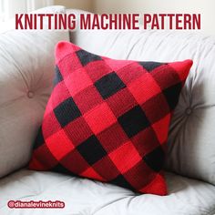 a red and black plaid pillow sitting on top of a white couch next to a window