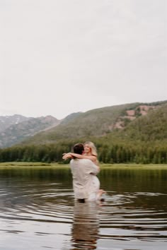 a man and woman are hugging in the water