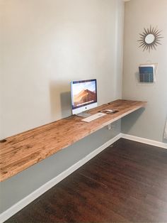 a desk with a computer on it and the words diy floating desk under $ 100