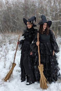 two women dressed as witches in the snow