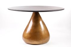 a round table with a metal base and a marble top on an isolated white background