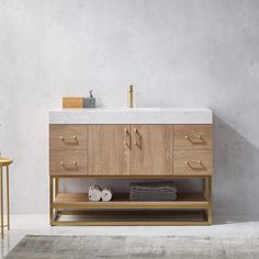 a bathroom vanity with marble top and wooden drawers