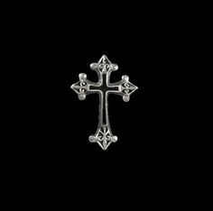 a silver cross on a black background