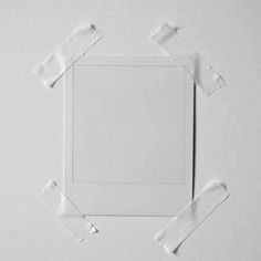 an empty square with torn pieces of white paper