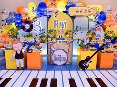 an image of a birthday party setting with balloons and music themed decorations on the wall