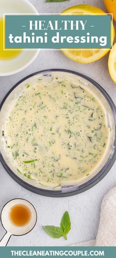 a bowl filled with broccoli and cheese next to sliced lemons