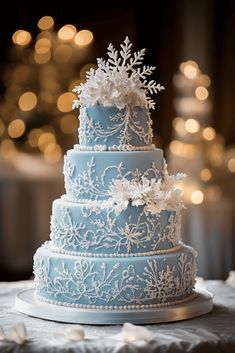 a blue wedding cake with snowflakes on it