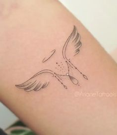 a tattoo on the arm of a woman with a bird flying above her left arm