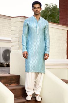 Featuring a sky blue kurta in cotton silk and georgette base with mirror machine embroidery. It is paired with contrasting churidar pants. . #perniaspopupshopmen #whatiworewastrending #ppuslove #kurtas #kurtaset #kurtasformen Indian Wedding Clothes For Men, Wedding Kurta For Men, Kurta Pajama Men, Gents Kurta Design, Haldi Outfit, Gents Kurta, Blue Kurta