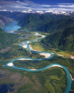 an aerial view of a river and mountains