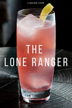 the lone ranger cocktail is sitting on a table with a lemon wedge in it's garnish