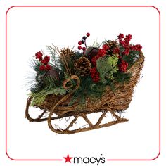 an old fashioned christmas sleigh with red flowers and greenery