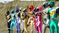 several different colored power rangers standing in front of a mountain side with their hands on their hips