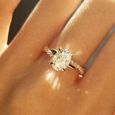 a woman's hand with a diamond ring on it