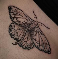 a black and white butterfly tattoo on the stomach