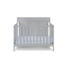 a baby crib with white sheets on the top and bottom, in front of a white background