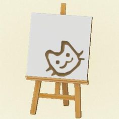 an easel with a drawing of a smiling face on it's front side