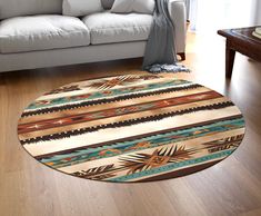 a living room with a couch, table and rugs on the wooden flooring