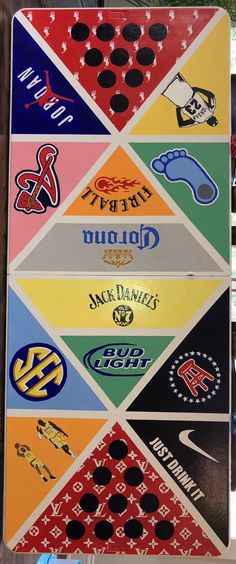 a close up of a street sign with many different stickers on it's side