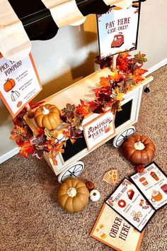 a table topped with cards and pumpkins on top of a carpet next to a window