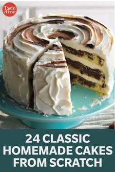 a cake with white frosting and chocolate swirls on top, sitting on a blue plate