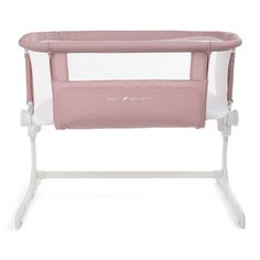 a pink baby crib with clear sides and white trim on the top, in front of a white background