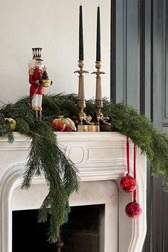 a mantel decorated with christmas decorations and candles