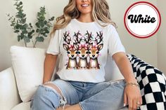 Handmade item Made to order Christmas Reindeer Shirt Cute Holiday Reindeer Trio Tee Christmas Graphic Tee for Women Funny Holiday Deer Shirt Christmas Lights Shirt FREE SHIPPING  MATERIALS ↠  Printed on a commercial printer with MADE IN USA INKS, safe for all inducing Toddlers.  ↠ All our simple solid color T Shirts like White, Black and Red are 100% Cotton. ↠ All our Heathered Color T Shirts are cotton/polyester blend and they are super comfy soft! ↠ Soft and High-Quality Fabric ↠ Sueded Jersey ↠ Pre-shrunk ↠ Taped shoulder-to-shoulder ↠ Tear away label ↠ Side Seamed ↠ Retail fit SIZE ↠ The shirts are unisex size--not women's fitted shirts. Womens can downsize their regular size if they want a fitted look. SHIPPING AND PRODUCTION TIME ↠ Production time is 1-2 business days (depending on p Reindeer Christmas Shirt, Santas Reindeer Shirts, Rudolph The Red Nosed Reindeer Tshirts, Reindeer Shirt Target, Reindeer Christmas Tshirt Unisex, Deer Shirt, Reindeer Shirt, Holiday Humor, Tees For Women