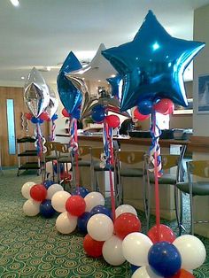 red, white and blue balloons are lined up on the floor