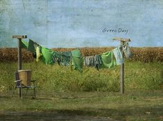 an image of clothes hanging out to dry in the grass with a chair next to it