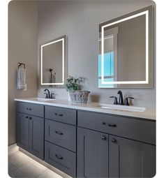 a bathroom with double sinks and two mirrors on the wall next to eachother