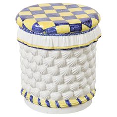 a white and blue basket with yellow trim