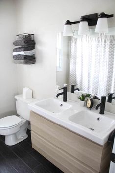 a bathroom with two sinks and a toilet