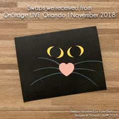 a black cat with yellow eyes and a pink heart on it's nose is featured in the article swaps we received from ontario november 2013