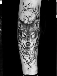 a man's leg with a wolf tattoo on it