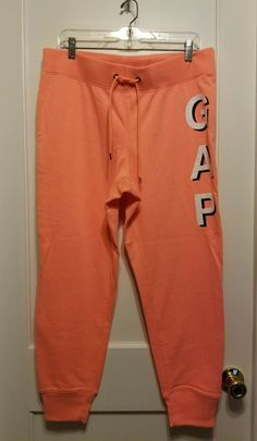 Gap Logo French Terry Joggers, Sweatpants, Orange, Cotton Blend, Size L, NWT Color: orange with white/black distressed letters logo. French terry knit. Drawcord ties at elasticized rib-knit waist. Gap logo print at front. Banded rib-knit cuffs. Sits at the natural waist. Slim though the leg. 60% Cotton, 40% Polyester. Machine wash Imported Length: Regular: 27" inseam. Waist: 18", measured laid flat. From a smoke free and pet free environment. Final sale. No returns please. Thank you! Sporty Gap Sweatpants For Streetwear, Casual Orange Sports Pants, Sporty Gap Joggers For Loungewear, Orange Cotton Athleisure Bottoms, Orange Relaxed Fit Sweatpants For Loungewear, Relaxed Fit Orange Sweatpants For Loungewear, Gap Relaxed Fit Cotton Sweatpants, Casual Orange Sweatpants For Sports, Gap Cotton Sweatpants With Elastic Waistband