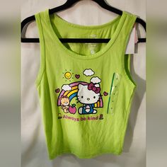 This Is A Hello Kitty Tank Top In Size Med. Lime Green In Color With "Always Be Kind" Printed In Hot Pink On The Front With A Summery Hello Kitty Picture. It Is 58% Cotton 38% Polyester And 4% Spandex. Very Cute And Soft Addition To Someone's Summer Wardrobe. There Are 2 Available Same Size Both New With Tags. Y2k Sleeveless Top With Hello Kitty Print, Hello Kitty Print Sleeveless Top For Spring, Playful Hello Kitty Tops For Spring, Spring Hello Kitty Playful Tops, Playful Sleeveless Top With Hello Kitty Print, Multicolor Hello Kitty Tops For Summer, Summer Multicolor Hello Kitty Tops, Multicolor Hello Kitty Print Tops For Spring, Green Kawaii Tops For Spring