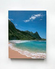 a painting of the ocean with mountains in the background