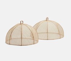 two white round baskets with handles and netting on the sides, one is open to reveal a