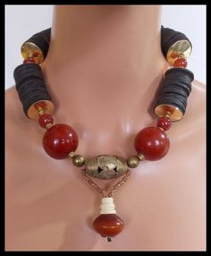 1 of a Kind!  Beautiful beads in this necklace Large, handmade @@ber @@sin beads from Morocco, hand carved off-round Carnelian beads, hand carved African coconut shell discs, handmade African brass beads, very old handmade tiny African clay beads and hand carved bone bead.  I have handforged brass domed discs to "encase" the coconut shell discs.   Necklace fastens with my signature, large, fancy handforged bronze clasp and soldered link brass chain. Length adjusts from about 20 - 22 inches. NOT Unique Handmade Carnelian Beads, Carnelian Necklaces With Large Beads, Unique Carnelian Necklaces With Large Beads, Unique Brown Necklace With Spacer Beads, African Inspired Jewelry, African Brass Beads, Pebble Jewelry, Large Bead Necklace, African Beads Necklace